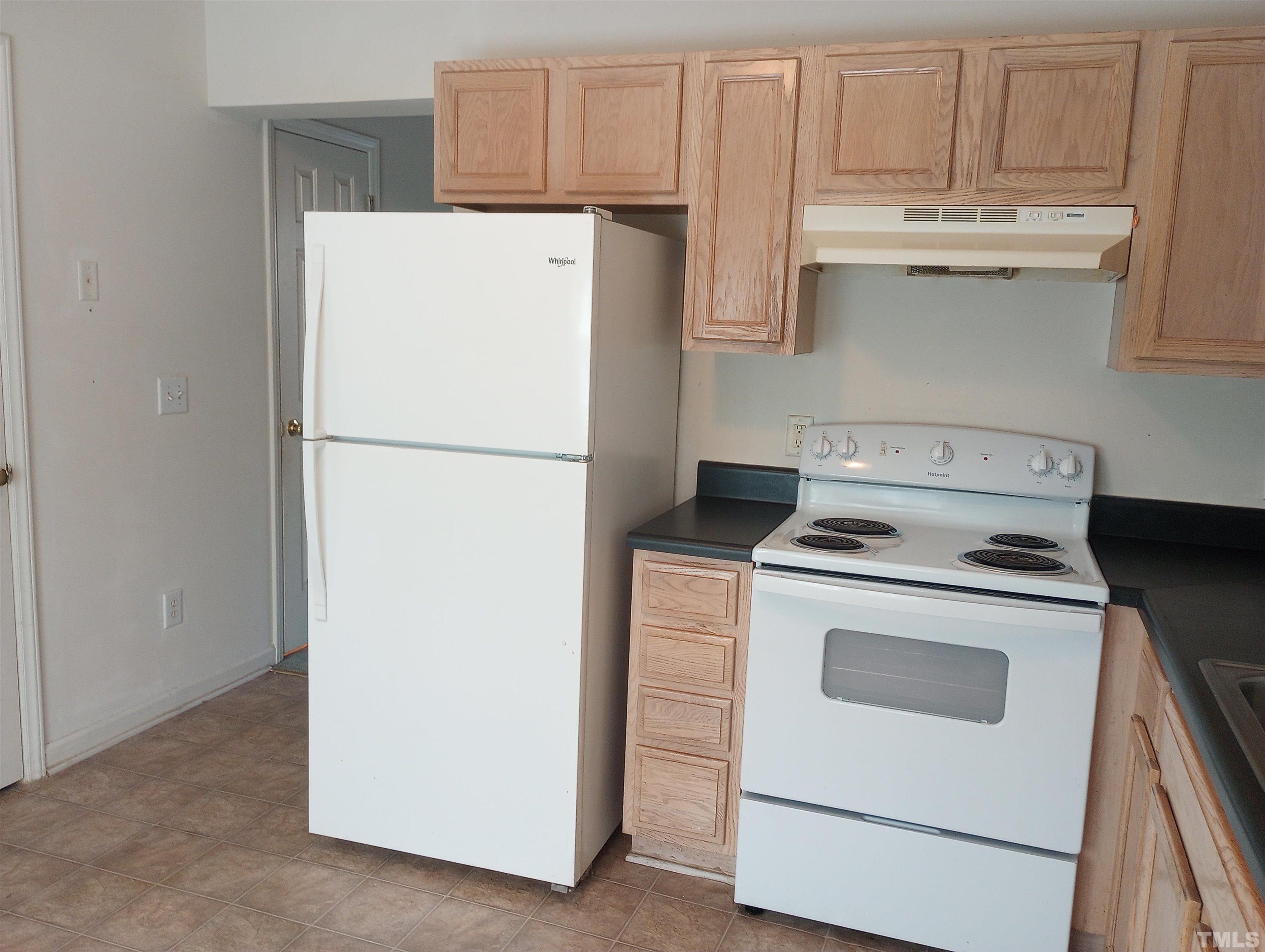 65 Red Lane Raleigh, NC 27606 - Photo 7 of 24 a white refrigerator freezer and a stove sitting inside of a kitchen