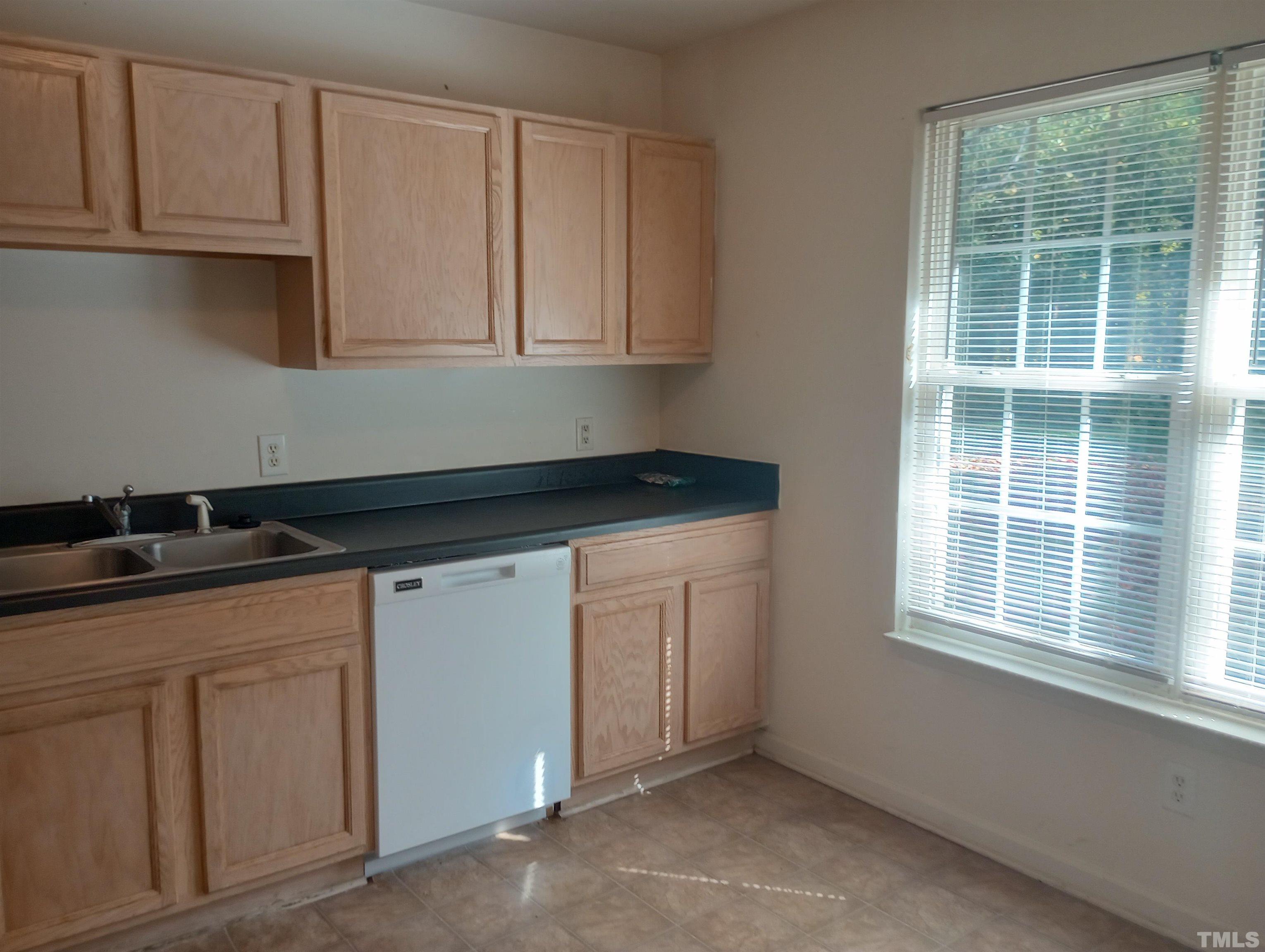 65 Red Lane Raleigh, NC 27606 - Photo 8 of 24 a kitchen with granite countertop white cabinets and sink