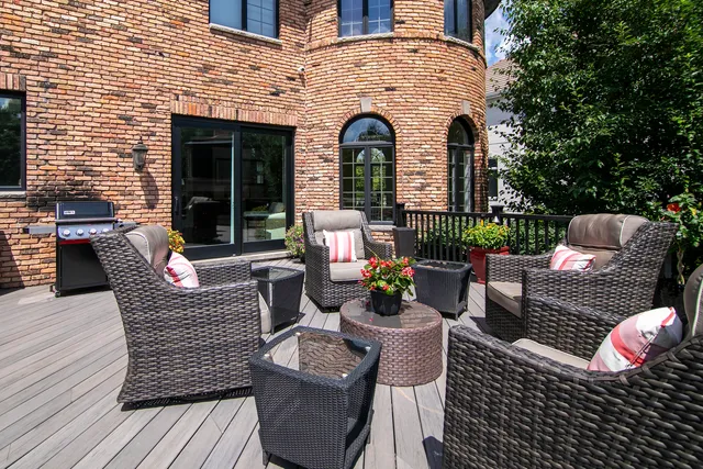 a view of a chair and table in the back yard