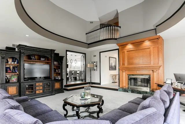 an aerial view of a house with a yard and lake view in back