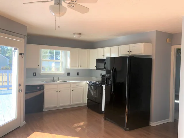 a kitchen with a refrigerator a sink and cabinets