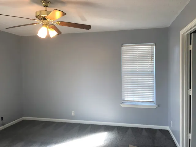 a view of room with window and ceiling fan