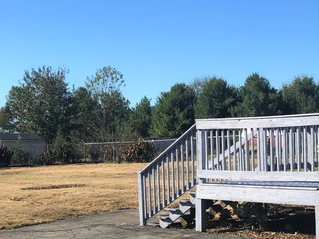 a view of a wooden deck with a yard