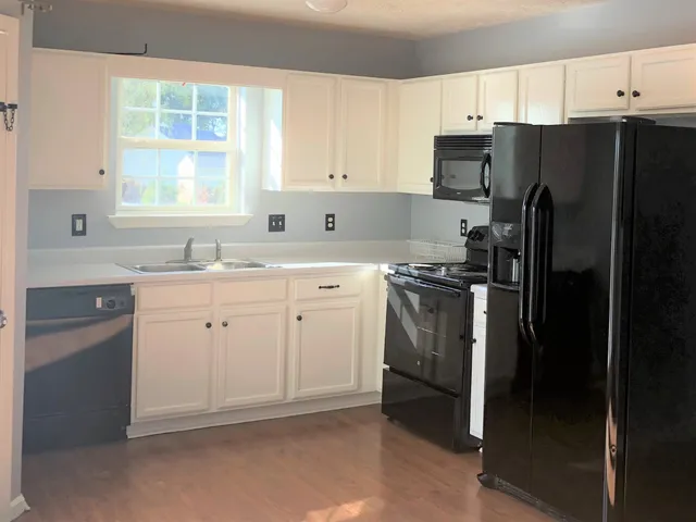 a kitchen with a sink stove and refrigerator
