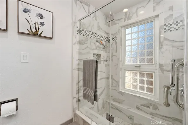 a bathroom with a tub and a window