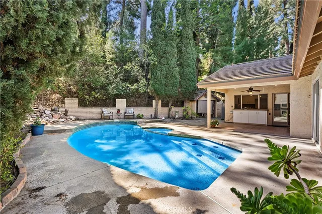 a view of a house with swimming pool and sitting area
