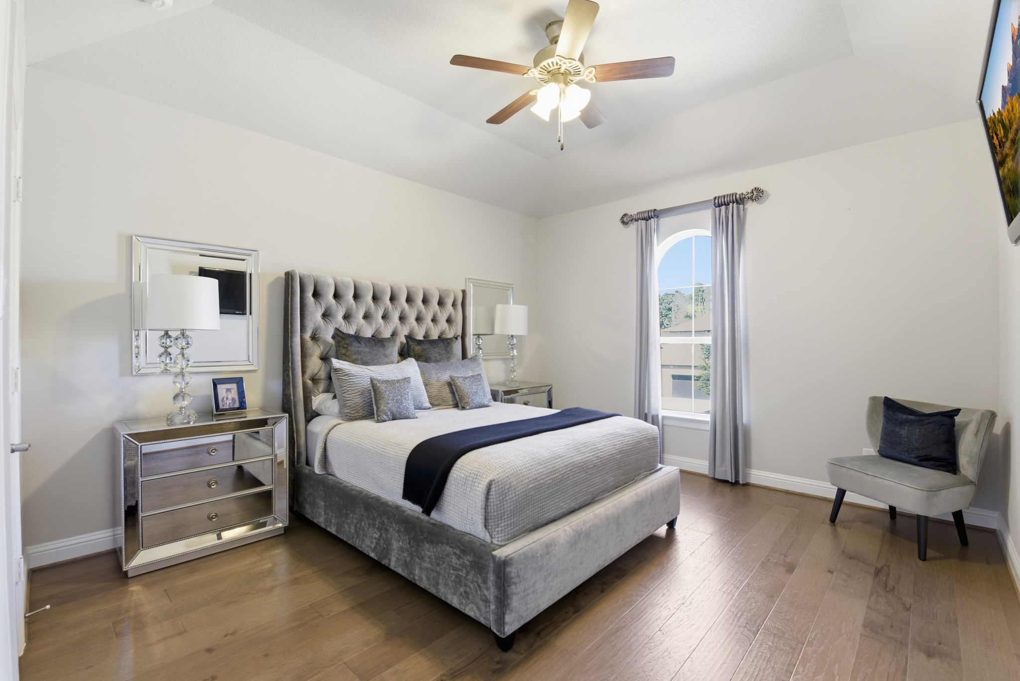 5811 Stratton Woods Dr Spring Spring, TX 77389 - Photo 33 of 38 a bedroom with a bed and a chandelier