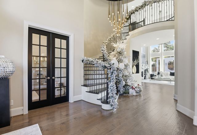 a living room with furniture a fireplace and large windows