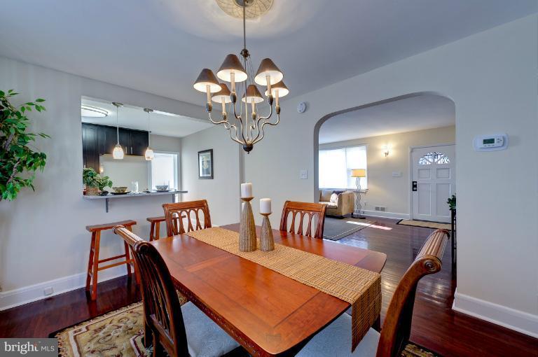 713 Charing Cross Road Baltimore, MD 21229 - Photo 1 of 29 a view of a dining room with furniture wooden floor and chandelier