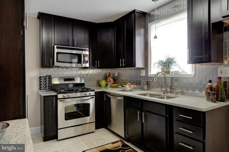 713 Charing Cross Road Baltimore, MD 21229 - Photo 28 of 29 a kitchen with a sink stove and microwave