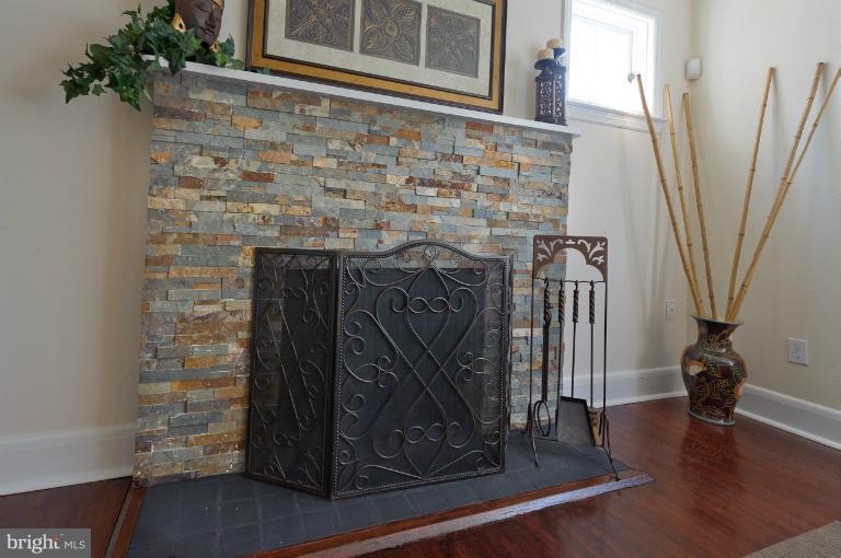 713 Charing Cross Road Baltimore, MD 21229 - Photo 8 of 29 a view of a fireplace with wooden floor