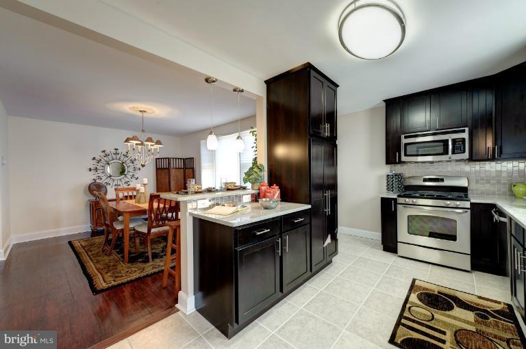 713 Charing Cross Road Baltimore, MD 21229 - Photo 9 of 29 a kitchen with cabinets and stainless steel appliances