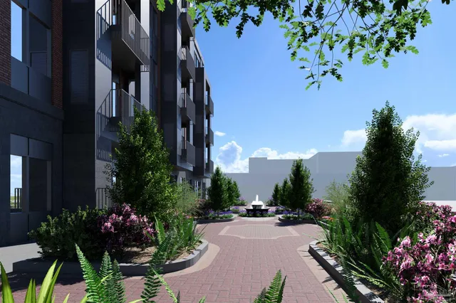 a view of a house with a yard and garden