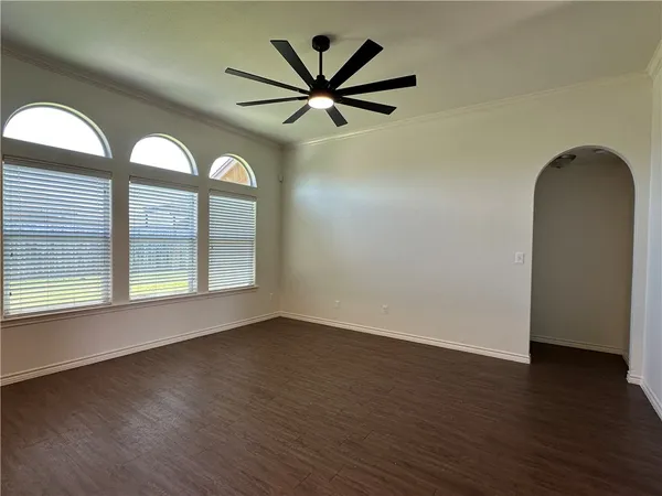 a kitchen with stainless steel appliances granite countertop a sink cabinets and wooden floor