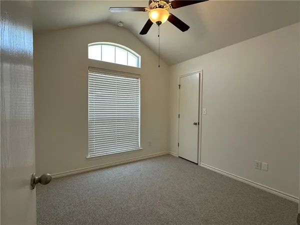 a bathroom with a granite countertop toilet sink and mirror