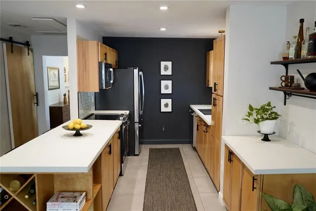 a kitchen that has a table and chairs in it