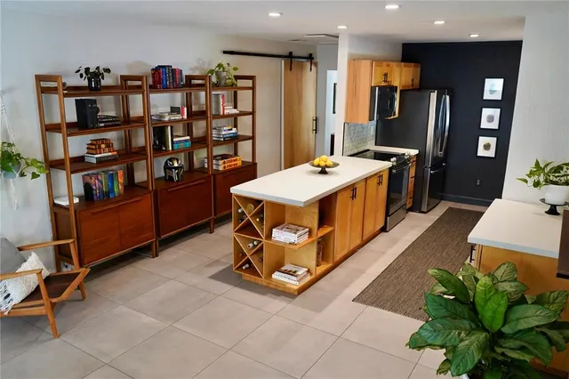 a room with pool table and a bookshelf