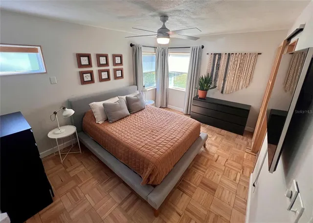 a bedroom with a bed rug window and wall painting