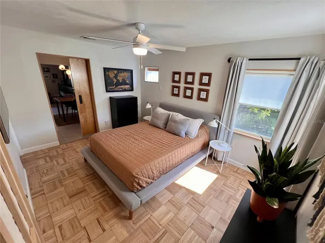 a bedroom with a large bed and a window