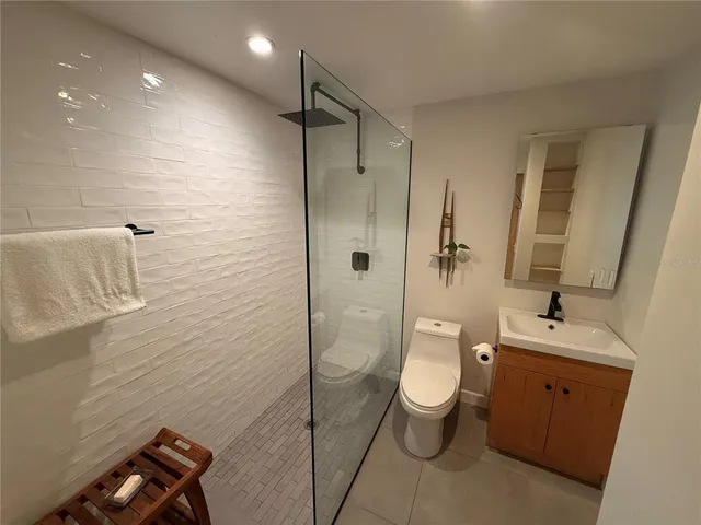 a bathroom with a toilet sink and shower