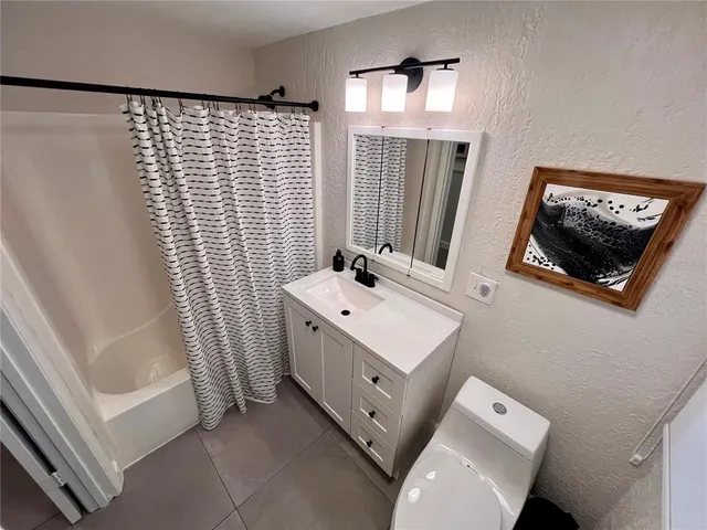 a bathroom with a sink a mirror and a shower