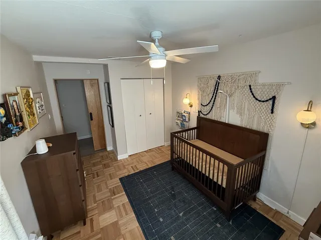 a view of a hallway with wooden floor and stairs