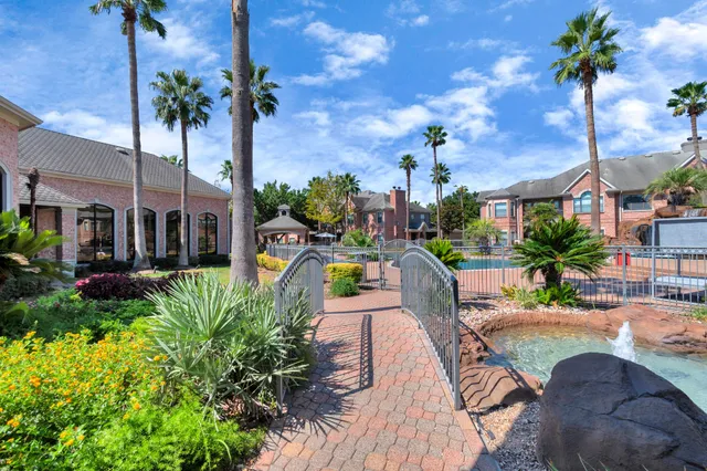 a view of a swimming pool with a patio and a yard
