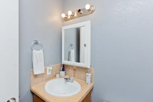a bathroom with a sink and a mirror