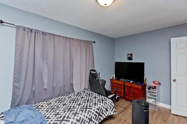 a bedroom with bed and tv