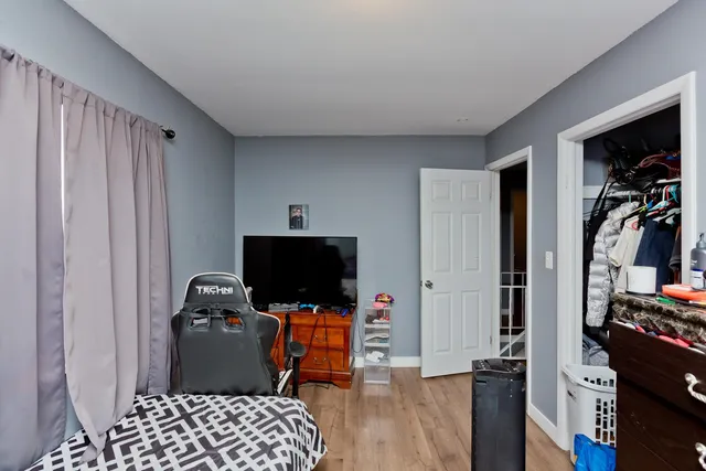 a view of room with workspace and wooden floor