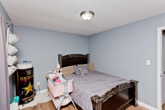 a bedroom with a bed and a fireplace