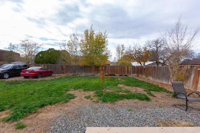 a view of a yard with a table and a chairs