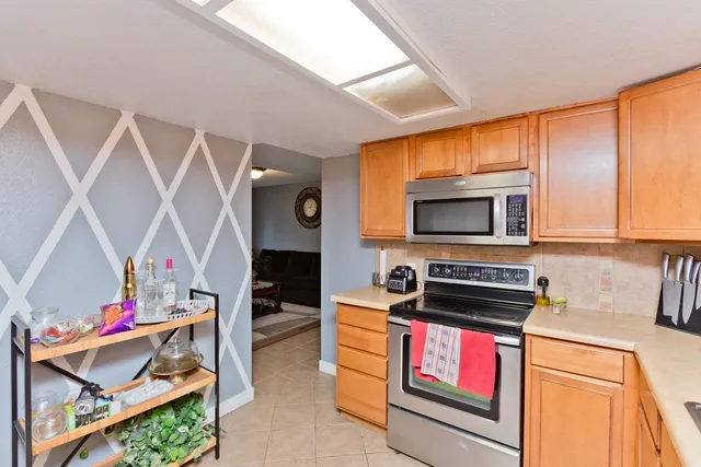 a kitchen view of microwave a stove and cabinets