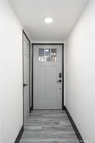 an empty room with wooden floor and closet