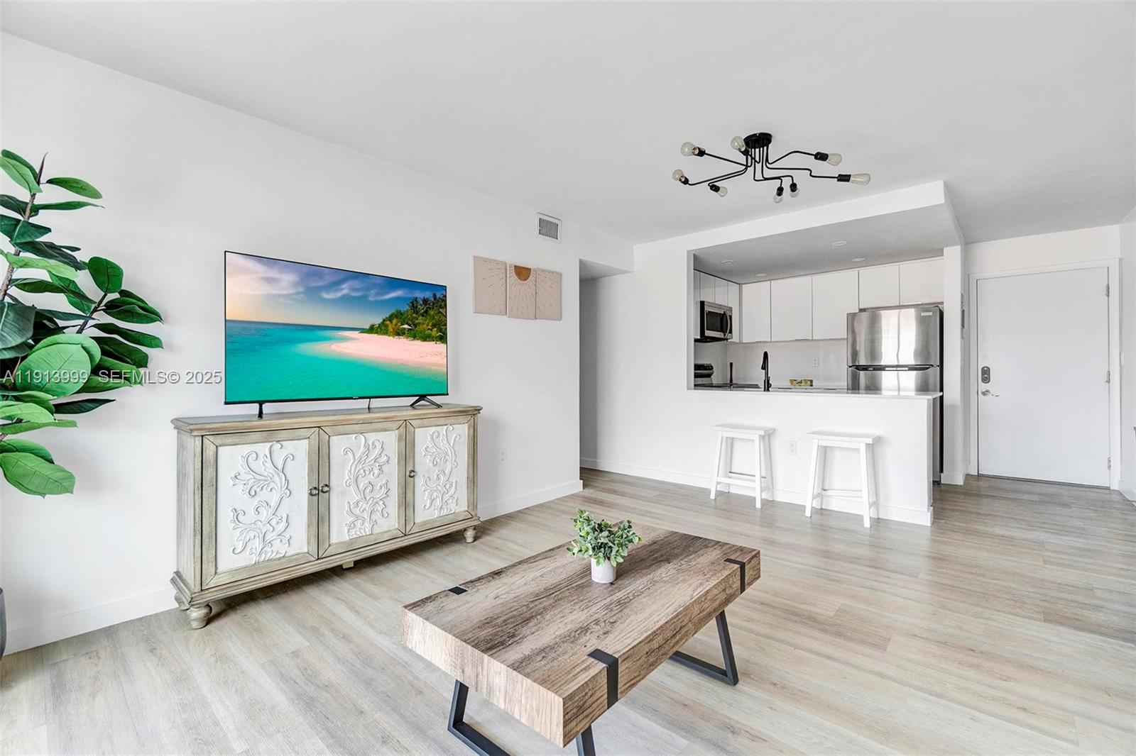 620 Southwest 10th Street, Unit 202 Miami, FL 33130 - Photo 1 of 20 a living room with furniture and a flat screen tv
