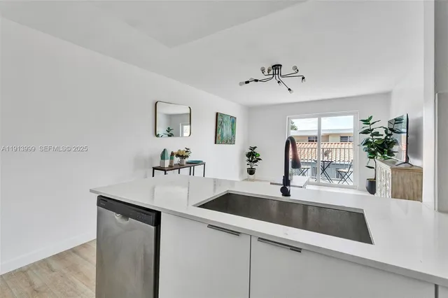 a kitchen with a sink and a refrigerator