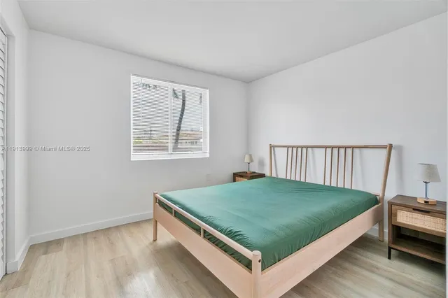 a bed sitting in a bedroom next to a window