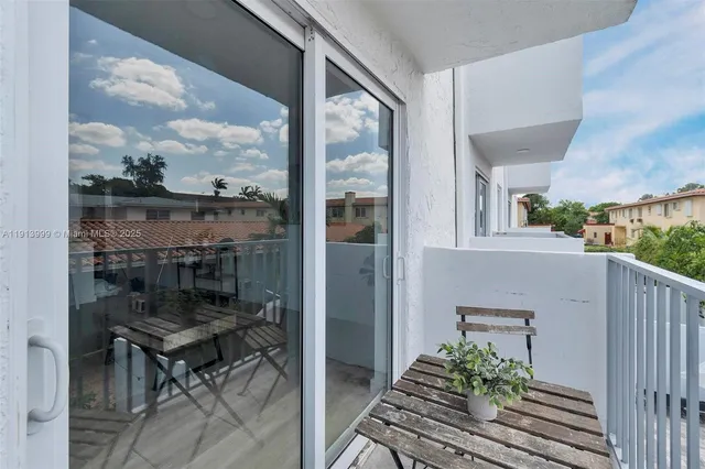 a balcony with furniture and a potted plant