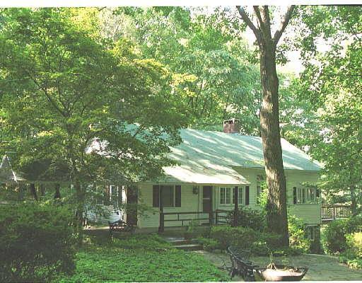 601 Rock Rimmon Road Stamford, CT 06903 - Photo 1 of 1 a front view of a house with a garden