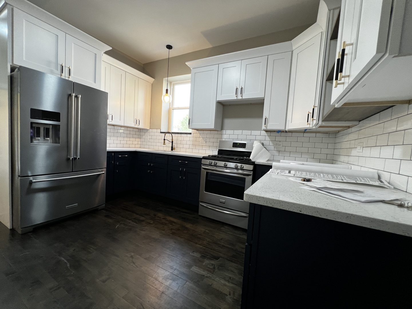 4956 West Erie Street, Unit 1 Chicago, IL 60644 - Photo 11 of 25 a kitchen with a sink stainless steel appliances and cabinets