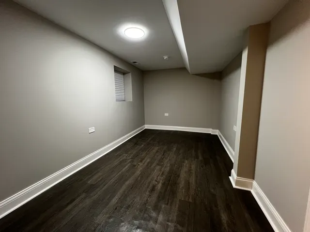 an empty room with wooden floor