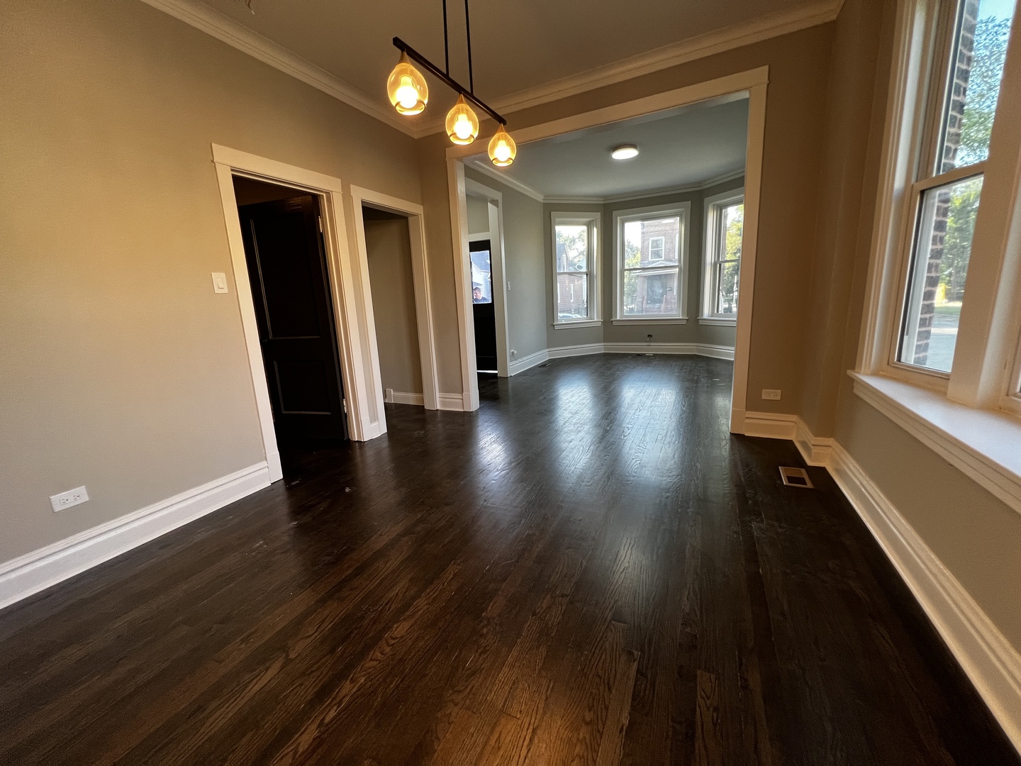 4956 West Erie Street, Unit 1 Chicago, IL 60644 - Photo 7 of 25 wooden floor in an empty room with a window