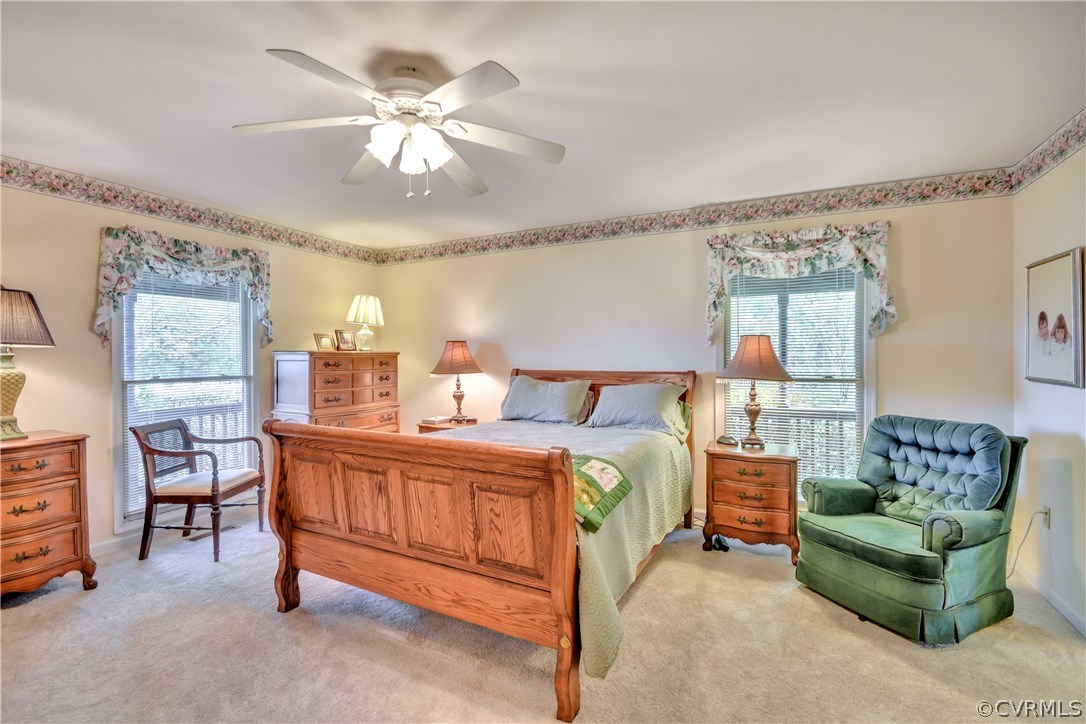 2661 Bibb Store Road Louisa, VA 23093 - Photo 14 of 35 a spacious bedroom with a bed and a chandelier
