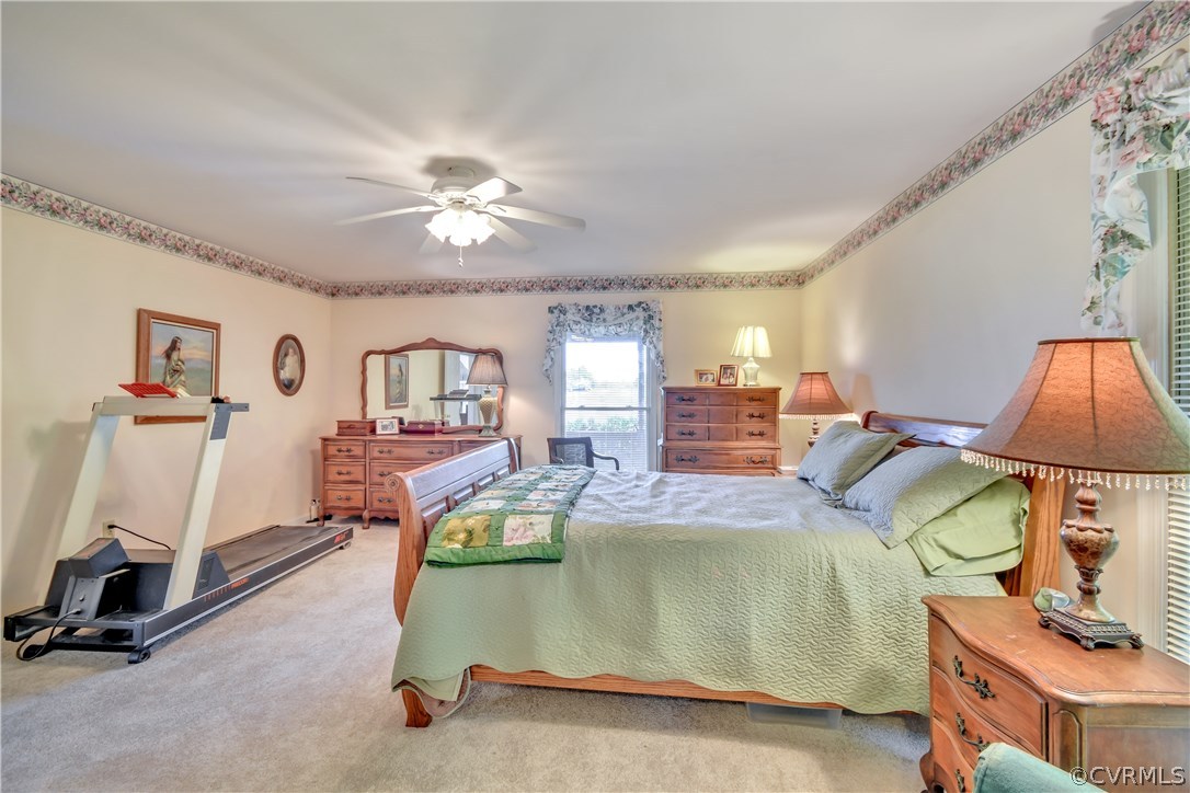 2661 Bibb Store Road Louisa, VA 23093 - Photo 15 of 35 a bedroom with bed and a chandelier