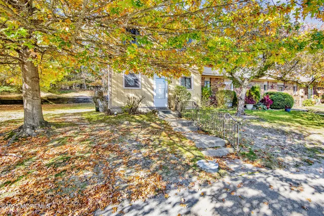 a backyard of a house with large trees