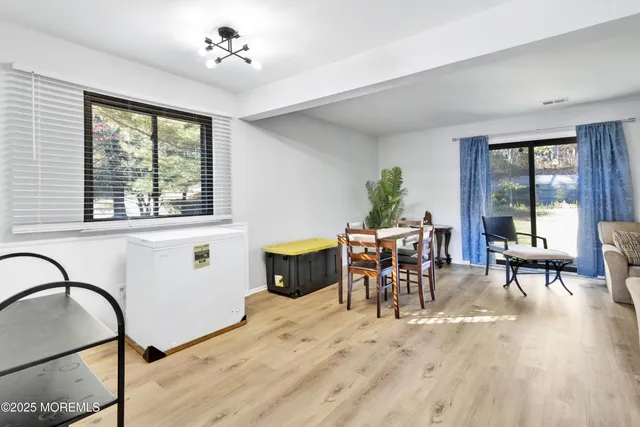 a workspace with furniture window and wooden floor