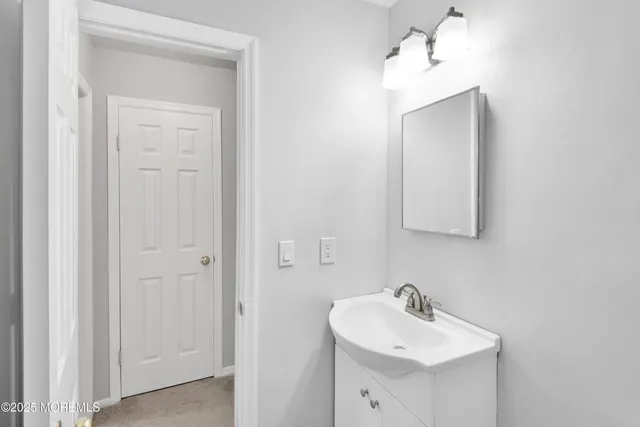 a bathroom with a sink a mirror and a vanity