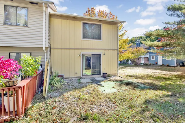 a front view of a house with a yard and flowers
