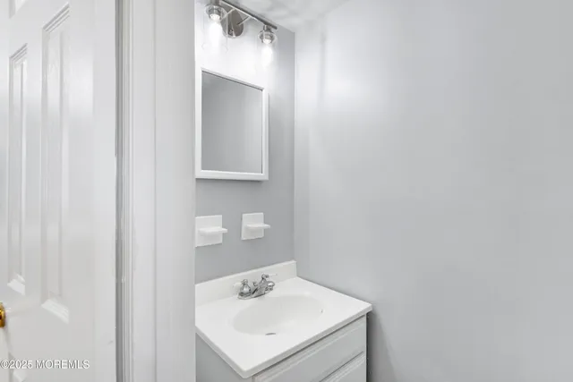 a bathroom with a sink a toilet and vanity