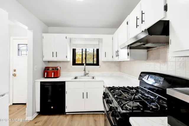 a kitchen with stainless steel appliances a stove and cabinets